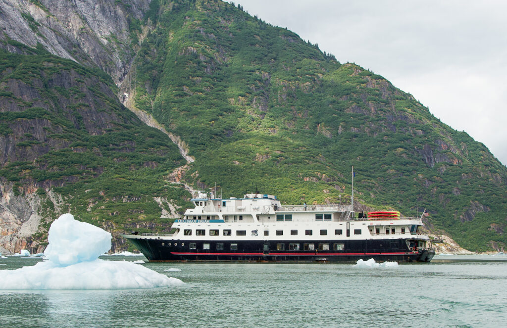 Alaska Dream Cruise ship in water with iceberg showing